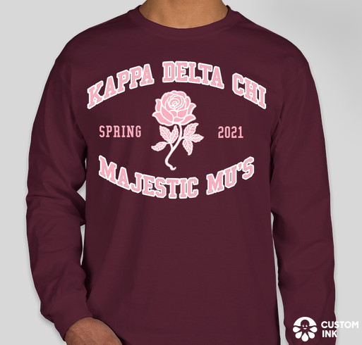 A mock-up of a long-sleeved burgundy shirt with a pink rose in the middle outlined in white. Pink text outlined in white above the rose says "Kappa Delta Chi". Below the rose says "Majestic Mus" On either side of the rose are the words "Spring" and "2021".